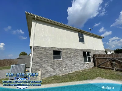 Wide-angle view of second story siding with visible chalky oxidation and faded paint