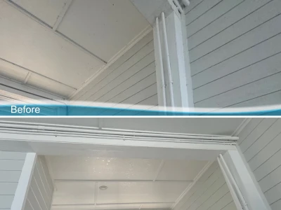 Softwash before and after of Hardie board siding on coastal patio in Galveston, Texas